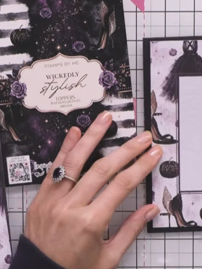 Step 1: Select a patterned frame topper from the Wickedly Stylish kit and trim it to size. Mount the trimmed topper on