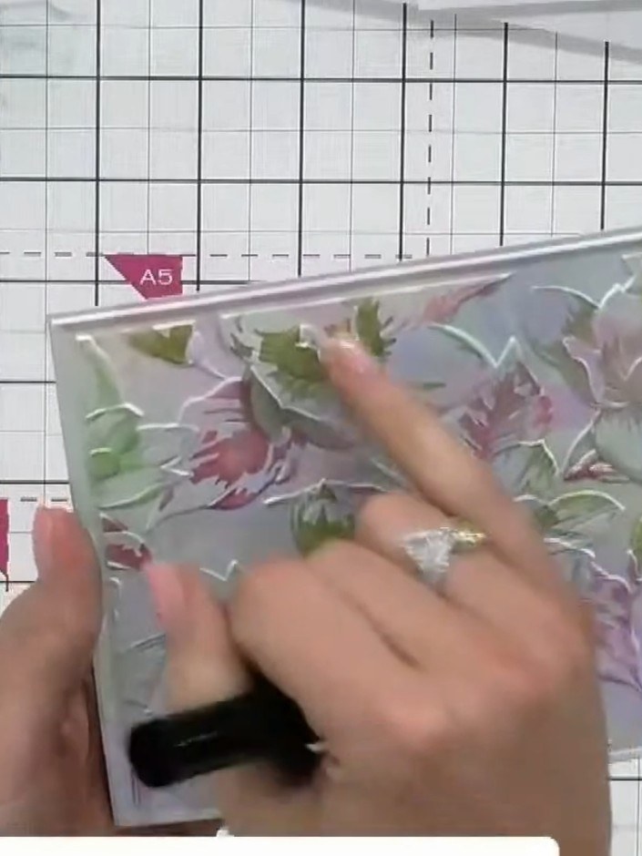 Step 6: Stamp your floral image onto the embossed and stencilled background, pressing firmly to ensure the stamp picks