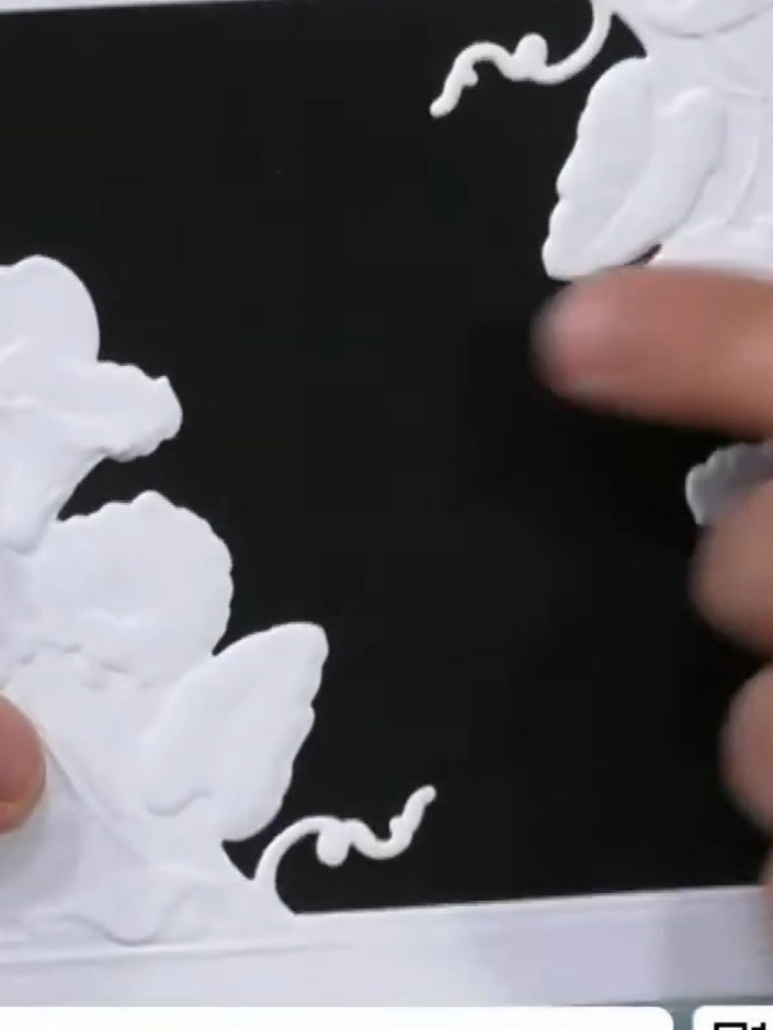 Step 4: Select one of the artistic mount pieces and trim the edges so it fits within the embossed window frame on your