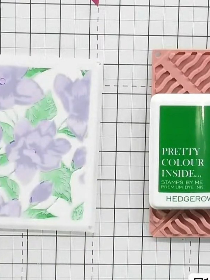 Step 4: Use the pink stencil to apply pink ink over the floral design, adding colour variation and detail to the flowe
