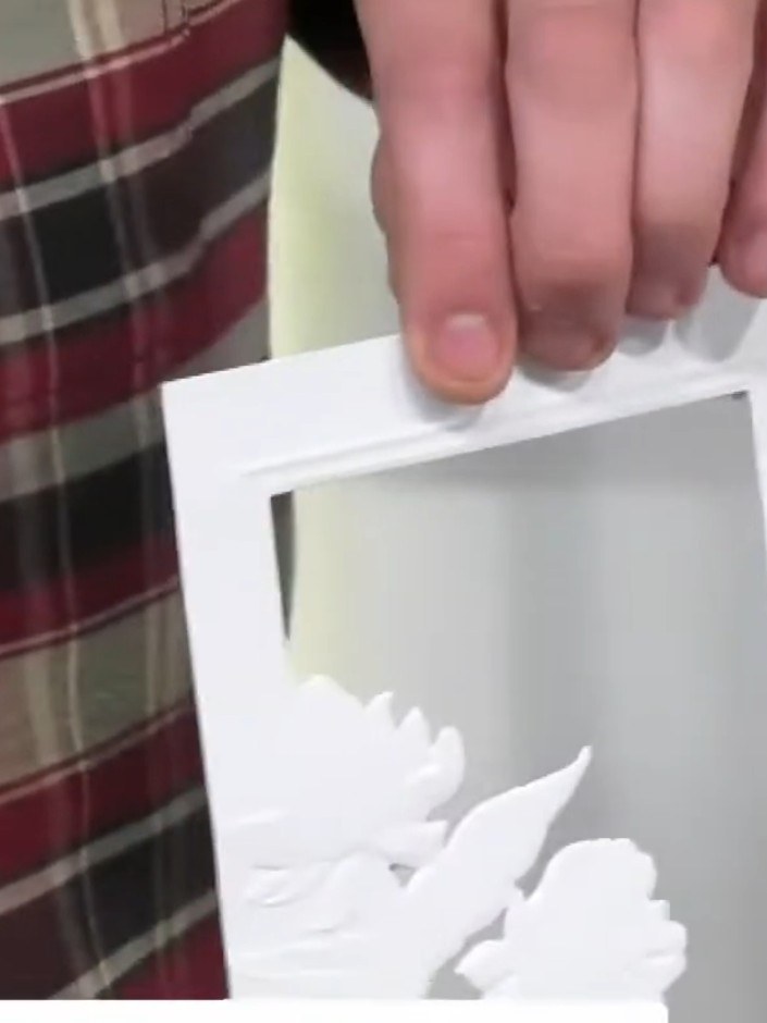 Step 6: Adhere the white embossed frame piece onto your card base using foam pads or glue, ensuring it is centred on t