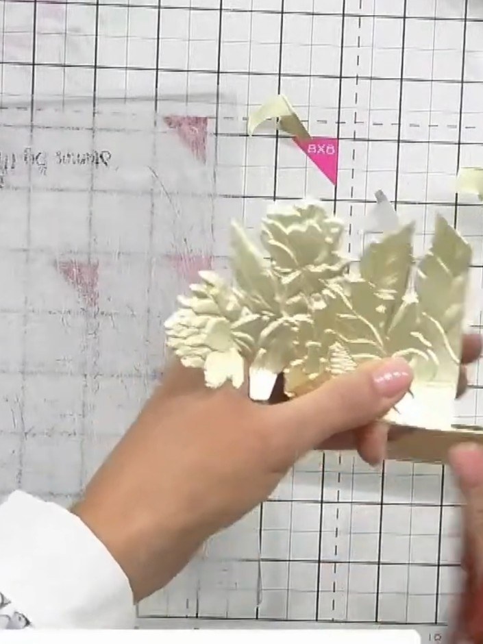 Step 7: Position your gold embossed floral piece behind the aperture window or add a sentiment topper to the centre of
