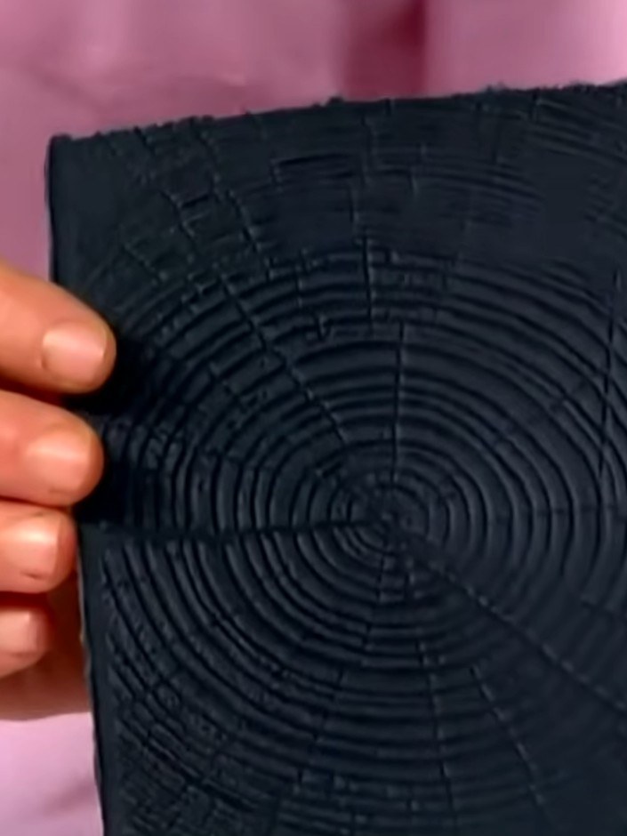 Step 3: Blend the black ink with your finger to create a softer, more natural wood appearance. Gently rub the ink acro