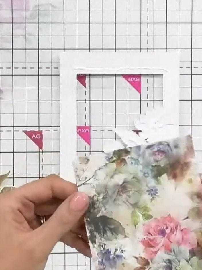 Step 2: Carefully remove the embossed and die-cut piece from the frame to reveal the white-on-white embossed frame wit