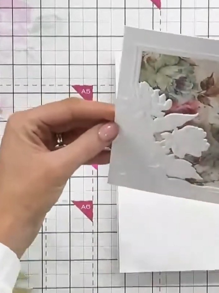Step 4: Position your chosen topper behind the embossed frame window and glue it in place, ensuring the image is centr
