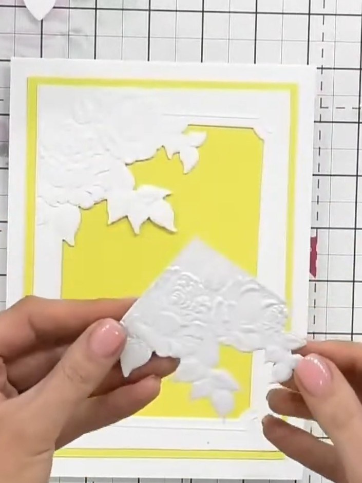 Step 4: Position the embossed white butterfly frame over the yellow card base. Glue the sentiment or topper behind the