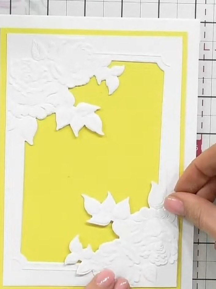 Step 7: Add decorative die-cut elements such as the 'WITH LOVE' sentiment or small hearts to the card front. Position 