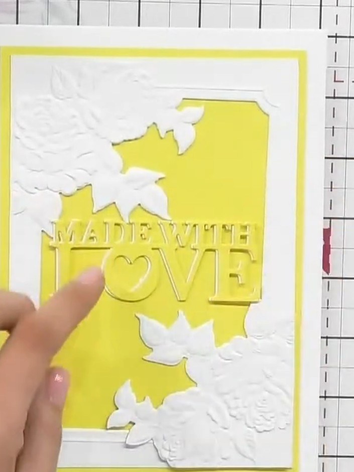 Step 8: Position the yellow 'MADE WITH LOVE' sentiment piece centrally on the card front. The finished card features t