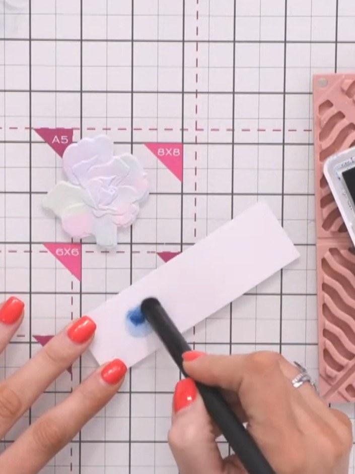 Step 4: Apply teal ink to the white card panel using an ink blending tool, working the colour into the embossed patter