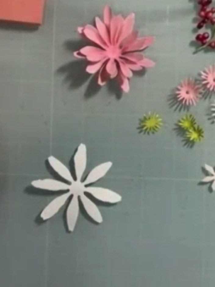 Step 1: Using the Gerbera daisy die set, cut two large petal pieces and two smaller petal pieces from white cardstock.