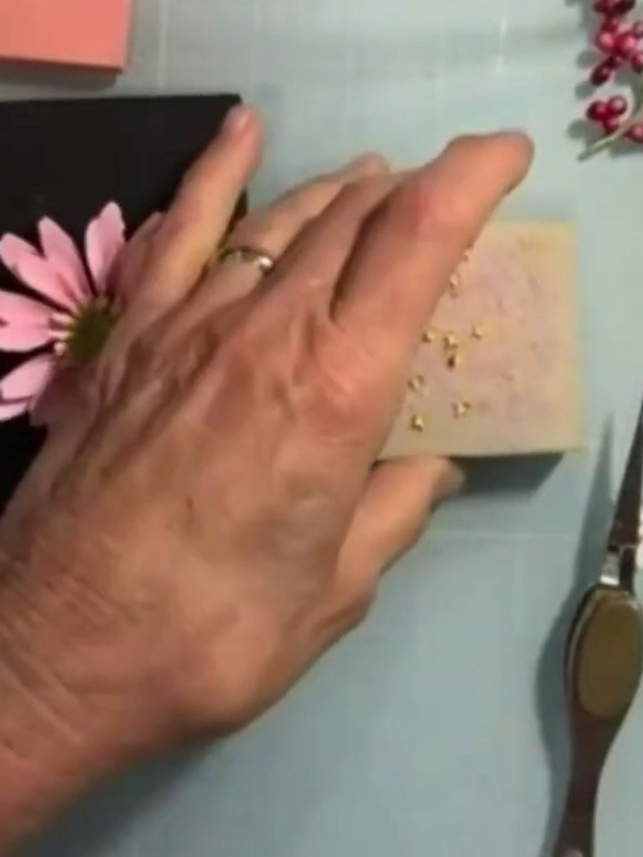 Step 10: Add small pearl embellishments to the centre of the pink gerbera daisy to create a hard, shiny finish like a r