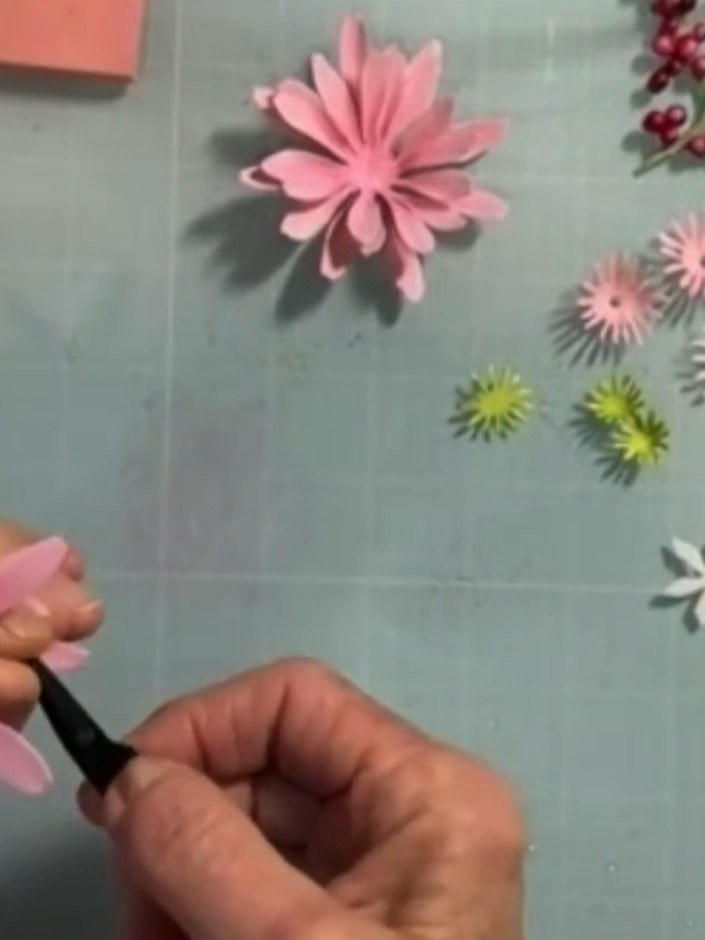 Step 4: Using tweezers, gently pinch each pink petal close to the centre to create natural curves and dimension. Work 