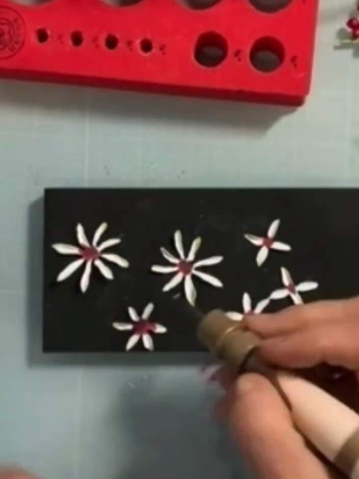 Step 3: Using a lighter shade of ink or chalk, add colour to the tips of the white petals to create shading and dimens