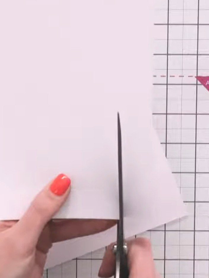 Step 6: Trim off the pointed tip at each corner of the box to remove the sharp point. This ensures the sides will sit 