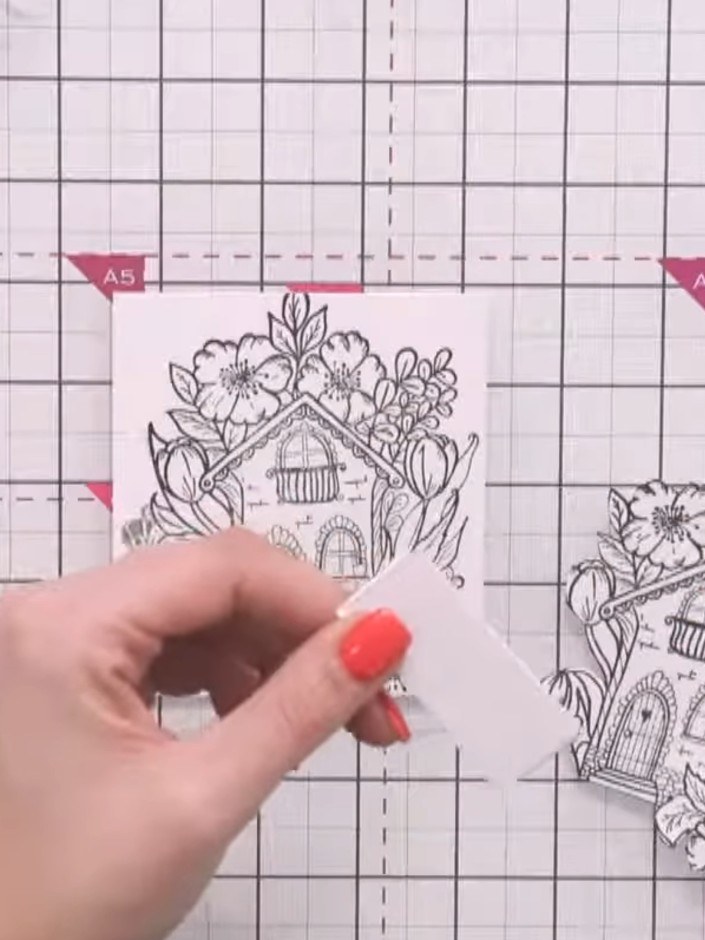 Step 4: Apply glue to the back of the first fussy-cut house layer using a glue pen. Attach it to the corresponding ima