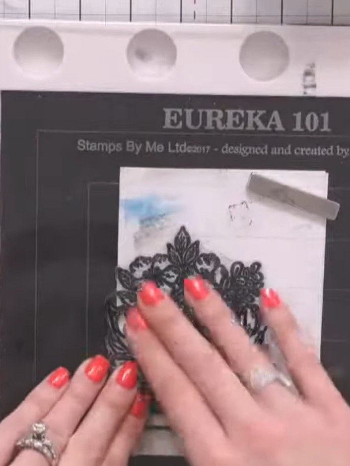 Step 2: Stamp the decorative house design with ink so that it hangs off the edge of the card blank, with part of the s
