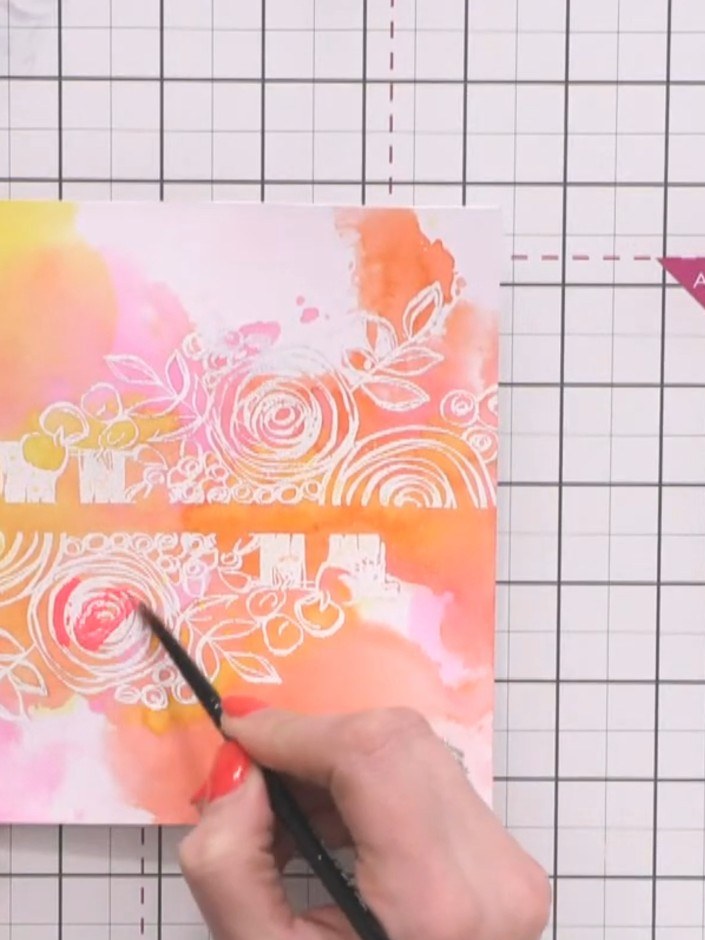 Step 10: Using a fine brush and neon watercolour paints, add fine details back into the white embossed floral design. L