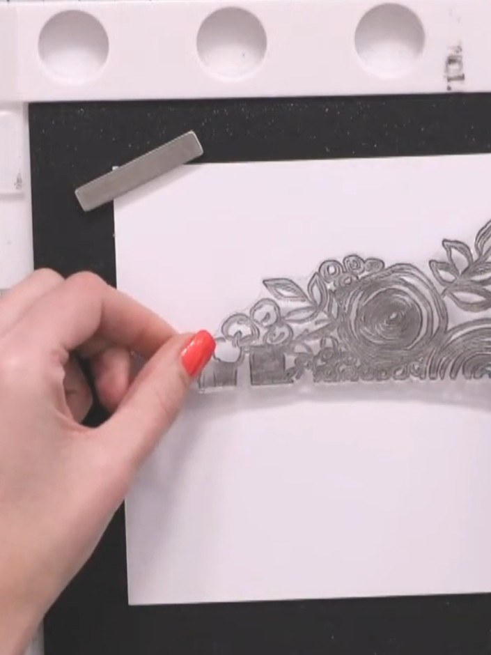 Step 3: Use an anti-static bag on the white card to prevent fingerprints. Position the floral stamp on the card and ap