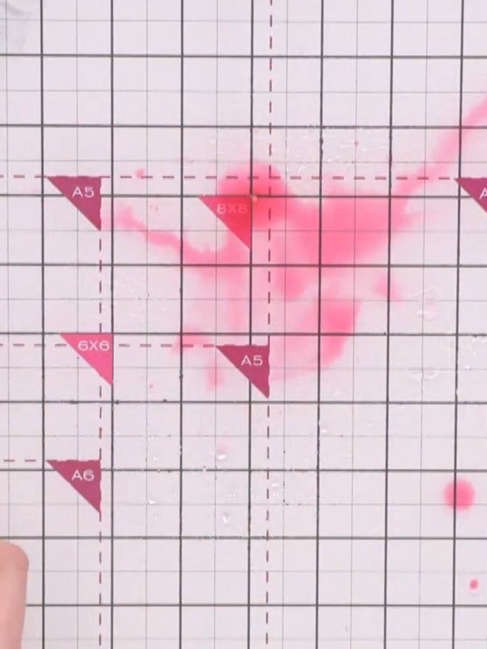 Step 6: Place your heat embossed card into the wet pink watercolour on your craft mat, allowing the colour to flow int