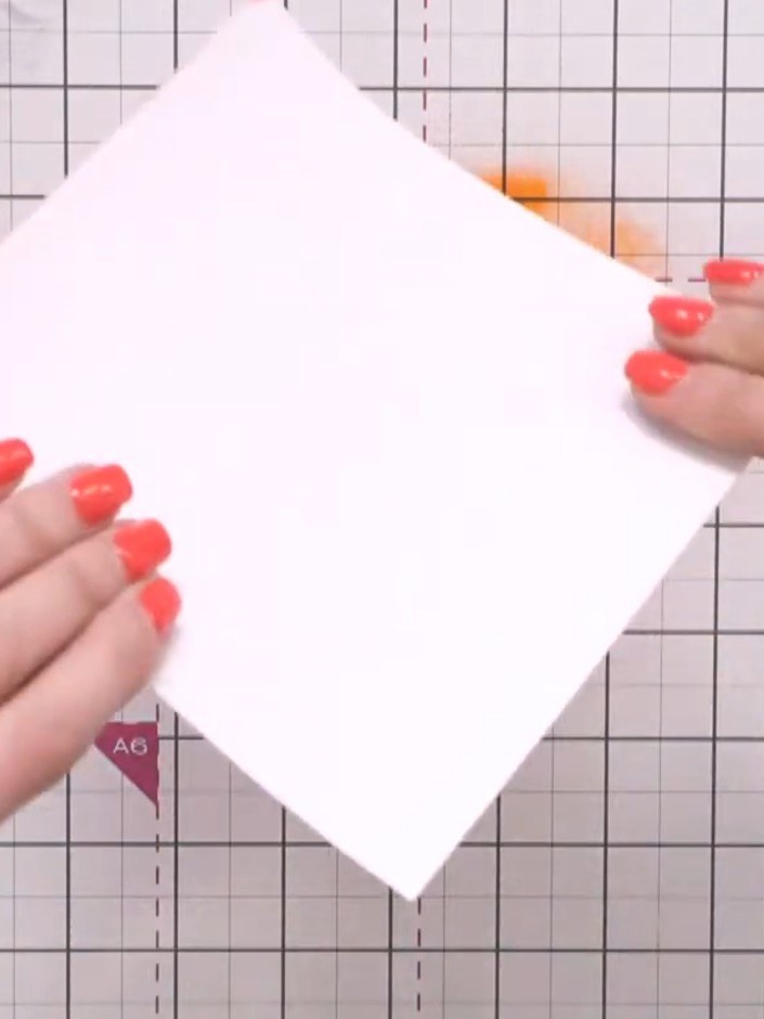 Step 7: Apply orange watercolour ink to another area of the craft mat. Place a fresh piece of white card face down ont