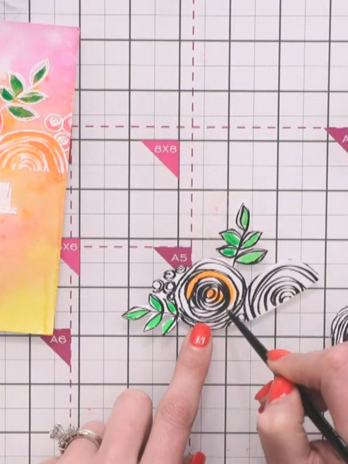 Step 3: Paint the leaves of the stamped flowers with green watercolour, deliberately leaving white space on one side o