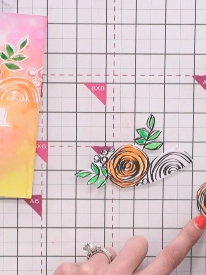 Step 4: Using a watercolour brush, add orange colour to the flower petals on the die-cut pieces. Leave some white area