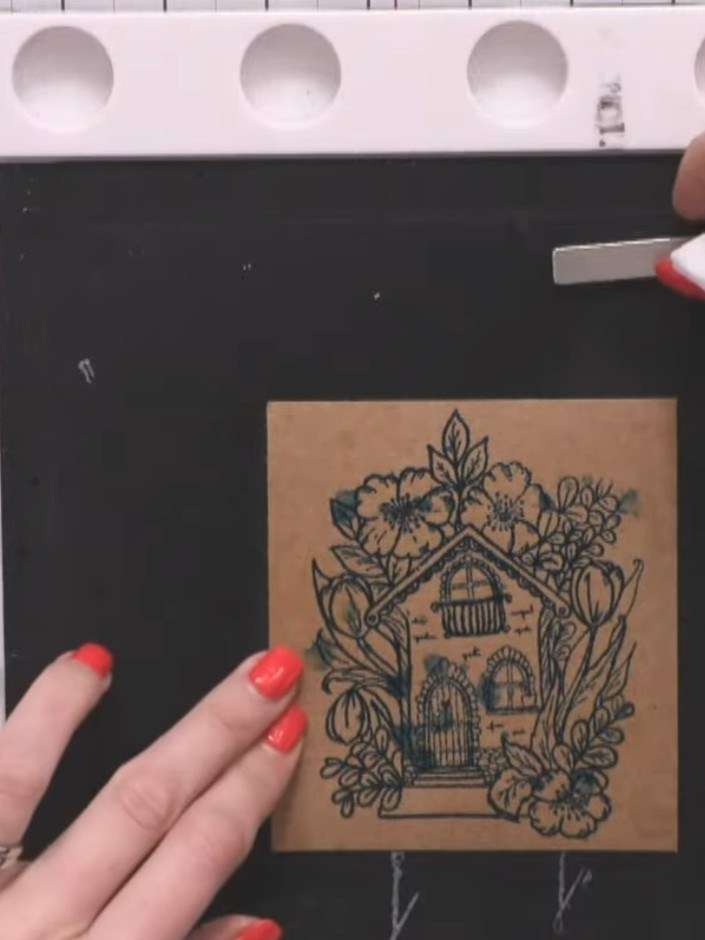 Step 3: Spray the stamped image lightly with water to create a soft bleed effect. Gently mop up excess water with tiss