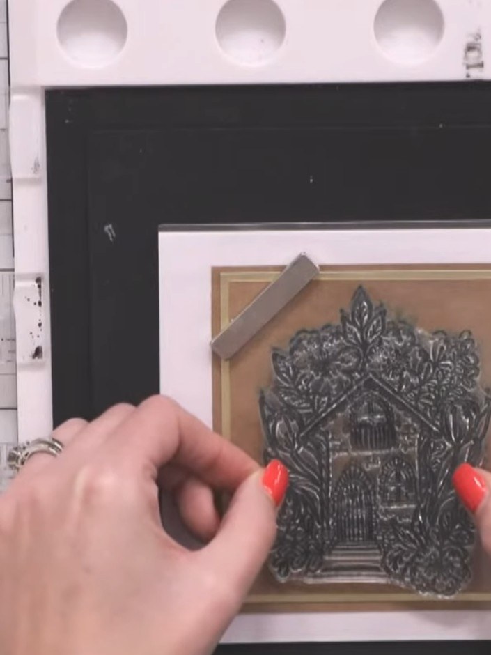 Step 8: Position the acetate overlay over your stamped design. Stamp the Happy Home image onto the acetate using white