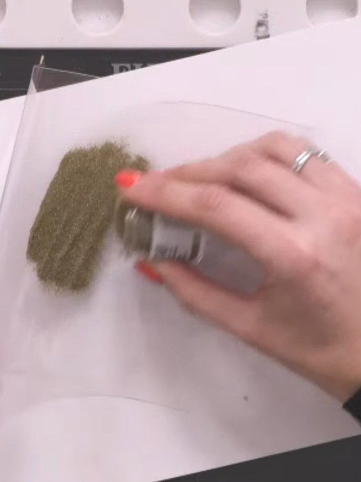 Step 9: Apply embossing powder generously over the stamped acetate image. Use an embossing brush to carefully brush aw