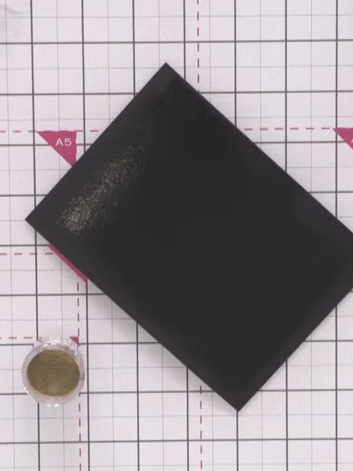 Step 3: Sprinkle metallic gold embossing powder over the inked black cardstock. Tap off the excess powder back into th