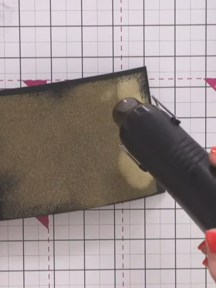 Step 6: Apply sticky embossing ink again to the same area of the black cardstock panel, covering the previously heat e