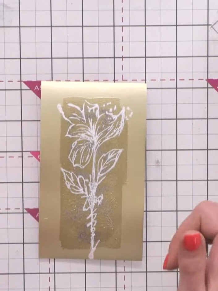 Step 11: Apply sticky embossing ink over the cooled embossed panel using the applicator, ensuring even coverage across 