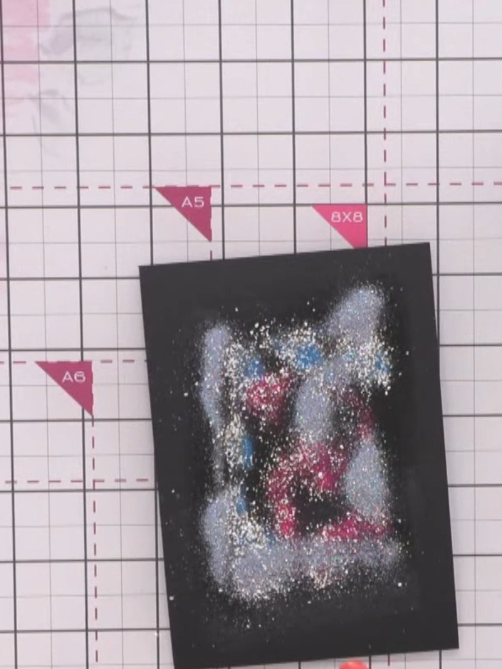 Step 10: Sprinkle gold embossing powder over the entire surface to seal the glitter in place. Ensure even coverage acro