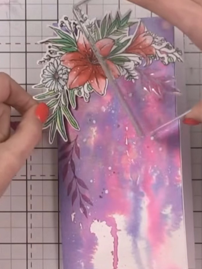 Step 10: Stamp additional leaves in a second colour, varying the direction to create a layered effect around the floral