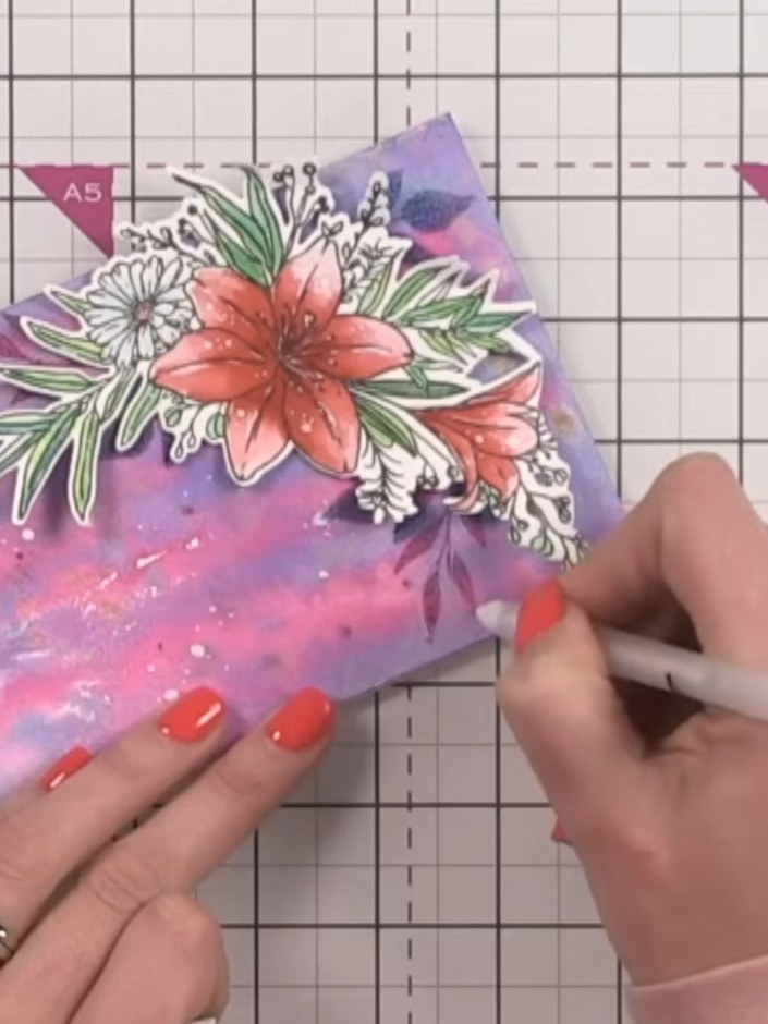 Step 12: Mount the stamped lily floral arrangement onto the inky splatter background card. Position it at an angle towa