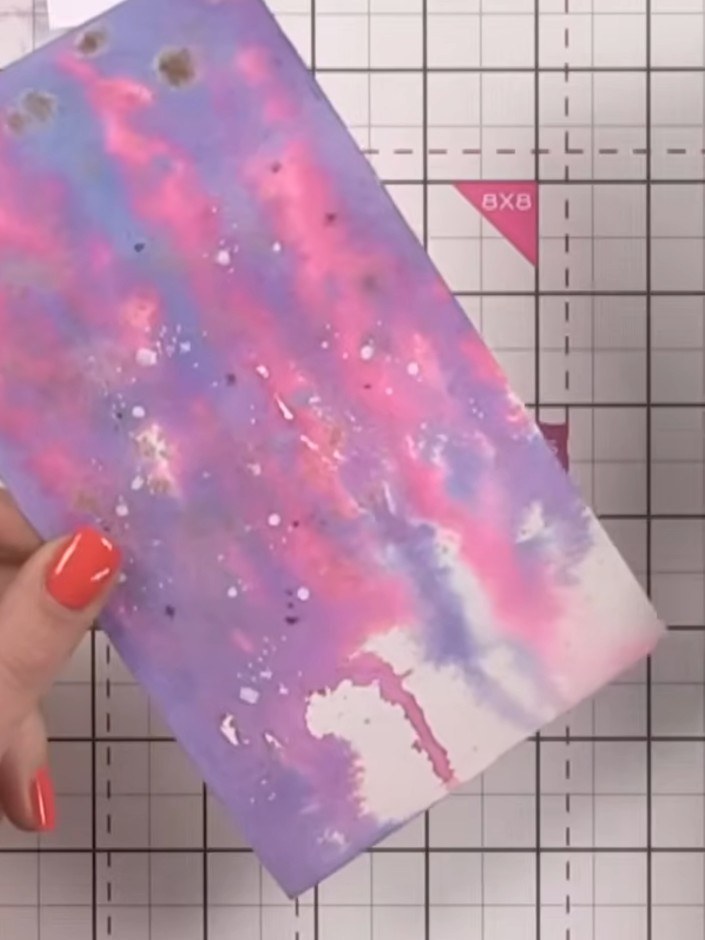 Step 2: Tilt the card at an angle and use a paintbrush to spot ink onto the surface, allowing it to drip down naturall