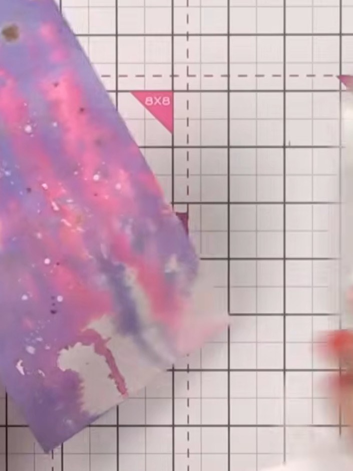 Step 3: Apply pink ink (Fandango) to the card, then let it dry. Wet the surface with water, then apply Ocean blue ink 