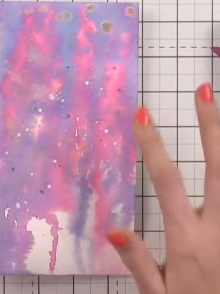 Step 4: Spray the card with water again. Apply ocean blue ink and splatter it across the surface. Allow to dry complet