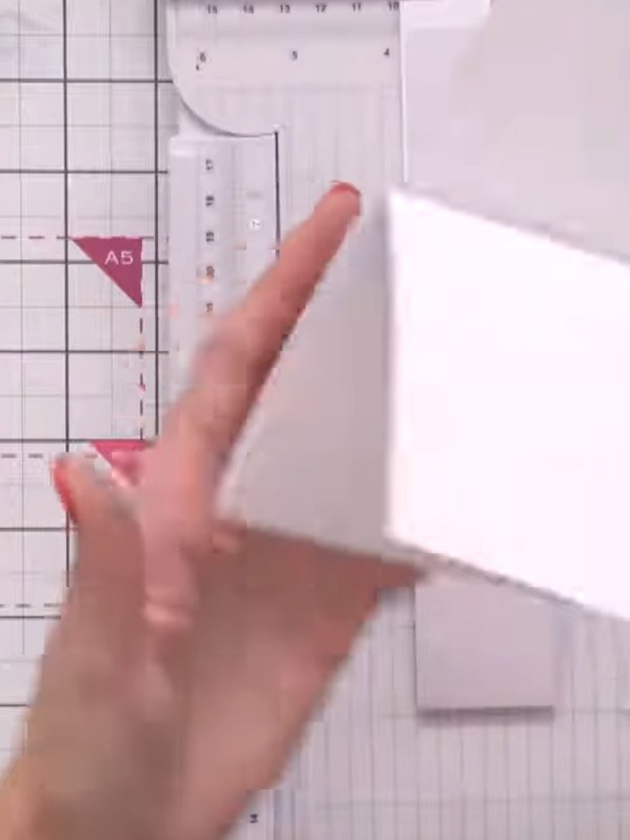 Step 3: Close the folded card and use a ruler and trimmer to cut approximately 1.5 inches (4 cm) off the bottom edge t