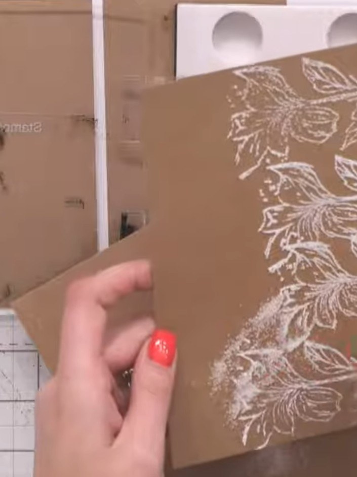 Step 9: Apply clear embossing powder over the heat embossed white leaf design on the kraft cardstock. Heat set the emb