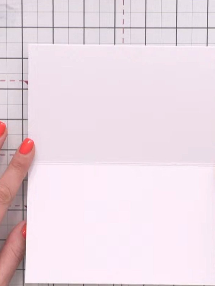 Step 1: Start with a top-folding note card measuring 8 by 6 inches. Score the card down the middle to create a centre 