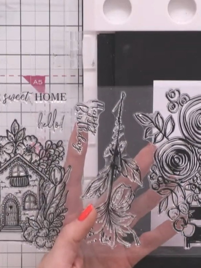 Step 3: Stamp the floral design with roses and leaves down the side of the first white panel using black ink, creating
