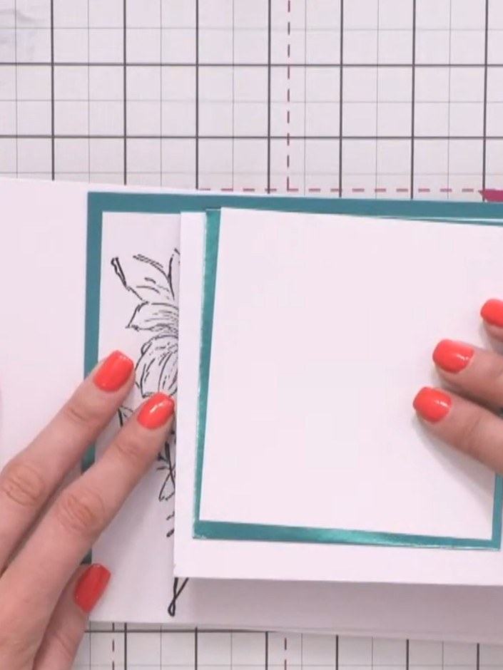 Step 7: Position the white panel with the teal border and floral stamps onto the Z-fold card, arranging it so the stam