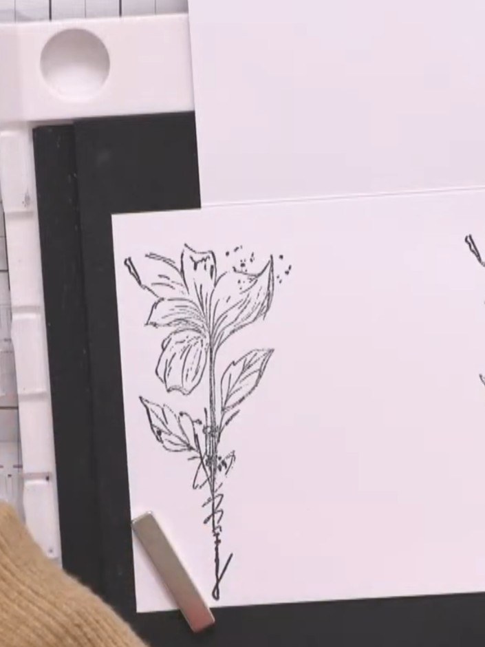 Step 8: Add colour to the stamped floral images using watercolour paint, applying it randomly and leaving some white s