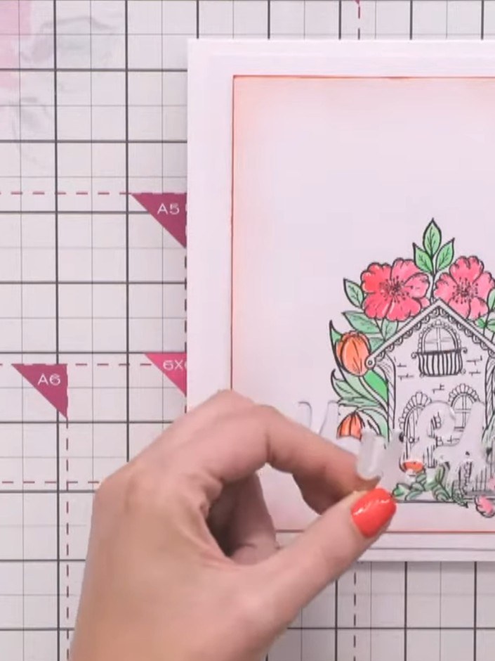 Step 13: Position the 3D 'You and Me' embellishment in the gap at the top of the card, ensuring the hidden message is c
