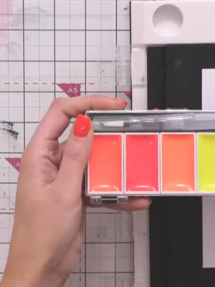 Step 2: Wet your watercolour paints with water to prepare them. Dampen your mat or use clean water in a jar for blendi