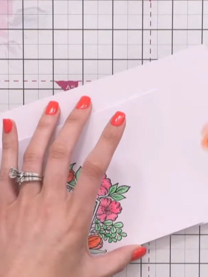 Step 6: Using a damp brush with minimal orange ink loaded, apply a soft wash around the entire edge of the card to cre