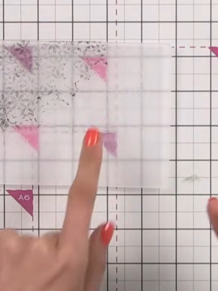 Step 3: Place the white cardstock into the embossing folder, pressing it firmly into the debossed areas where the pink