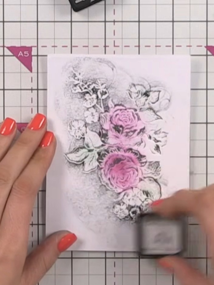 Step 2: Press the inked cardstock firmly into the embossing folder to transfer the pink ink onto the raised floral des