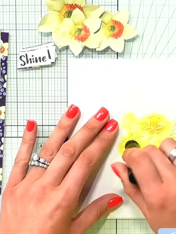 Step 3: Using orange pigment ink, layer colour in the centre of each stencilled daffodil flower to add depth and dimen